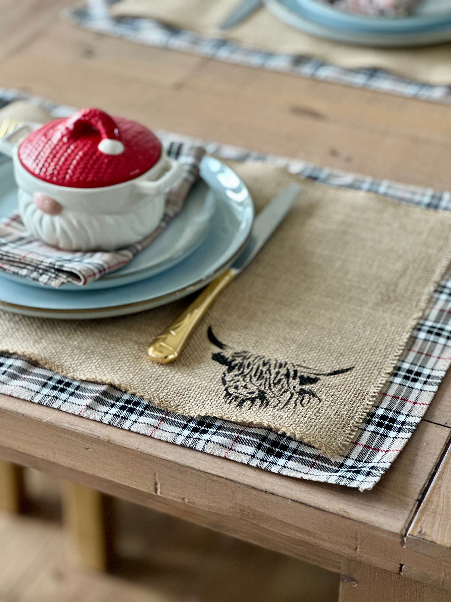 Neutral tartan placemats with highland cow